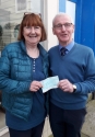 Hector Whitelaw receiving a cheque for £1000 from Marlene Hill of For Bute