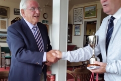 Jim Bicker presenting Tommy Wilkinson with Trophy